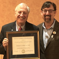 Dr. Miller (left) is shown accepting the AAP Clinical Research Award for 2015 for most outstanding clinical study. 