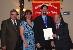 Dr. Levine is shown accepting a certificate from Dr. Present along with other Temple University Kornberg faculty.