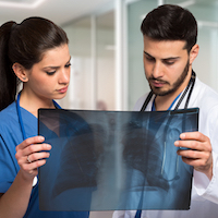 Medical workers looking at a radiography