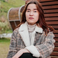 woman posing in plaid coat