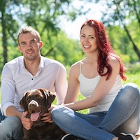 couple with dog in the park