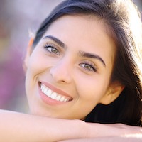 Brown Haired Woman With White Teeth Smiling