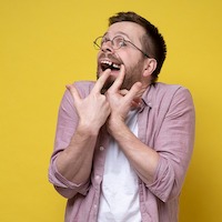 man pointing to missing tooth