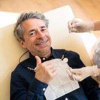 Older White Man Smiling During Dental Exam